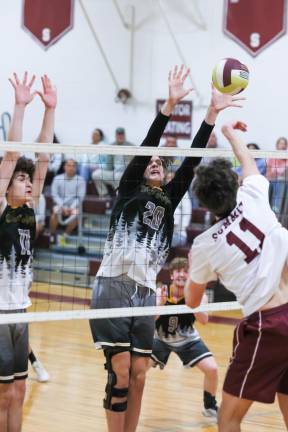 . Andre Christ tries for the block of a spike off the hand of Oliver Hogan of Summit.