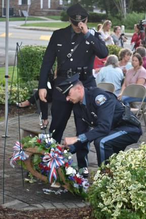 West Milford police officers lay a wreath at the 9/11 Monument in front of the municipal building.