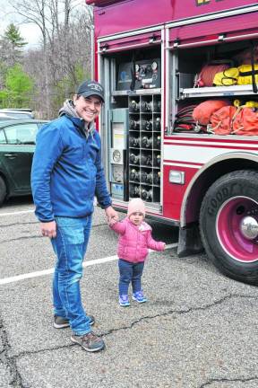 YC2 A father and child look at a firetruck.