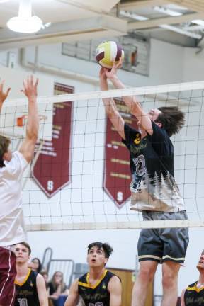 Matt Landoline directs a shot back over the net during play in the first game against Summit.