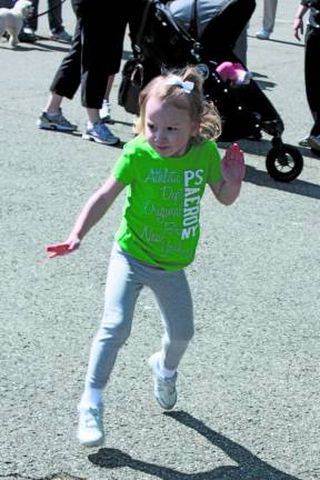 Photos by Ginny Raue Little feet do a little Irish Jig before the Irish Whisper Walk. Karley Labita, 3, is one of many participants who were dancing as a warm-up to the walk.
