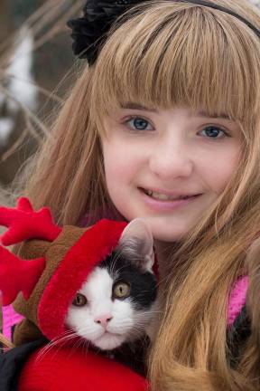 Submitted by Cristina Kiesel of Monroe, N.Y. "Clover's first Christmas. Clover is keeping warm in his reindeer costume."