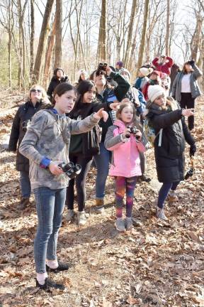 Ellen Raupp, right, of Ramsey points out a bird to her daughter, Emily, 9, second from left, and others taking part in the Great Backyard Bird Count.