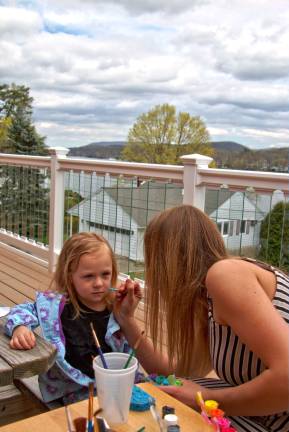 Brylee Riegler, 3, of west Milford gets her face painted at the Fox Island Creamery grand opening.