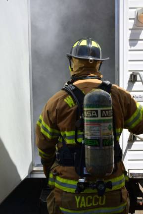 Firefighter Josh Yacco enters the smoke house at Fire Company 2's open house.
