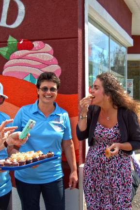 Elena Dykstra, left, owner of Fox Island Creamery,enjoys the moment as Mayor Bettina Bieri enjoys one of the stores cupcakes. "It was one of the best cupcakes I've ever had," said Bieri.
