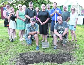 Attendees pose in front of the America250 Time Capsule plot, which will be reopened in 2076.