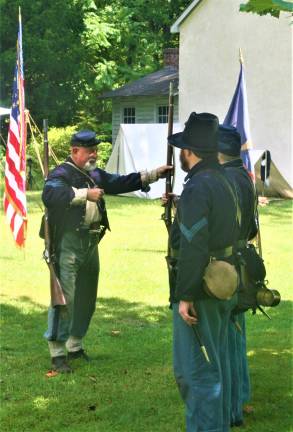 [Members of the 6th New Hampshire regiment Union Civil War reenactors hold a demonstration at the Long Pond Ironworks State Park in Hewitt on Saturday. Charles Kim photo]