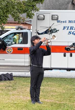 Prince Joshua Limos plays taps.