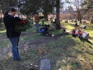Volunteers place wreaths on the graves of veterans at Cedar Heights Cemetery in West Milford. (Photo by Kathy Shwiff)