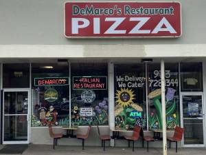 The local artist who decorated the windows of DeMarco’s Restaurant in Hewitt wants to remain anonymous. (Photo by Ann Genader)