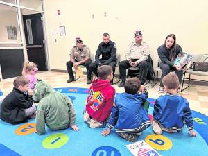 Rudy Hass, David Borowski, Marine and West Milford policeman; John Trojanowski, Army; Kalyan Autie, mother of Ezekiel and Enzo, and wife of a VFW member talk to children.