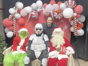 A member of the Northeast Remnant, the official Garrison of the 501st Legion, which celebrates ‘Star Wars,’ poses with Santa and an elf at the second annual Winterfest on Dec. 10 at Upper Greenwood Lake Elementary School.