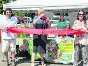 West Milford Mayor Michele Dale cuts the ribbon to open the Farmers' Market season.