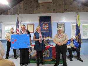 Teachers Kelly Frasca, left, and Jill Cullen present Bill Johnson, commander of West Milford Veterans of Foreign Wars Post 7198, with a check for $2,763.