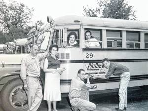 The Phillips family, Joe and Mae and their children Barbara, Gail, Joe Jr. and Bob, all bus drivers, are seen with their Phillips Transportation Company in 1958.