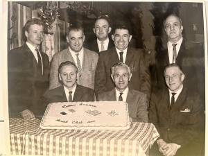 Members of the Italian American Club of West Milford at their first social function at the Beach Cliff Hotel in Upper Greenwood Lake in 1966. The cake has flags of the United States and Italy. Seated, from left, are Joseph Oddo, club president; Henry Cantaluppi; and Anthony Tucci. Standing, from left, are John Errico, James LaGreco, James Morreale, John Grecco and Frank Licursi. (File photo by Ann Genader)