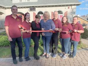 Pictured from left to right: Richie, Mary, Grace, Mayor Dale, Ted, Laura and Chris, the family and staff of Vault Liquors at its grand opening on Oct. 3. Provided photo.