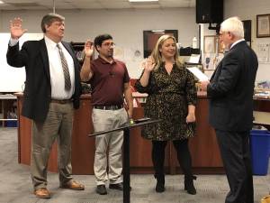 From left, Peter Lippe, William Cytowicz and Tara Racano are sworn in to three-year terms on the West Milford Board of Education by board attorney Andrew Brown at the reorganization meeting Jan. 3. (Photos by Kathy Shwiff)