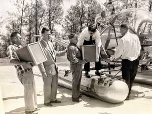 Trout packed in plastic containers are loaded into a helicopter at Greenwood Lake Airport in West Milford in 1960 to be dropped into West Pond on state park property by the New Jersey Conservation Department. (File photo by Ann Genader)