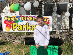 Thirty cars, led by a Town of Goshen Police Officer Luke Markievicz, drove by to wish 10-year-old Parker Olson a happy birthday.