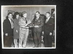 A flag that flew over the White House is presented to Veterans of Foreign Wars Commander George Breslin by lawyer Louis Wallisch Jr. to be flown at the post, 196 Lincoln Ave., in the 1950s. From left are Charles Andrews, Nancy Mays, Breslin, Wallisch and Councilman Joe Bender, post founder. (File photo by Ann Genader)