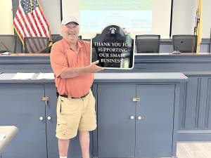 West Milford Environmental Commission Chair Steve Sangle holds a plaque he donated to the West Milford Economic Development Commission in backing efforts to support small businesses.