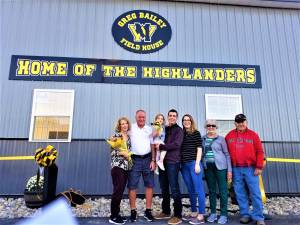 Greg Bailey and his family stand in front of the new field house bearing his name at McCormack Field during a Sept. 27 ceremony.