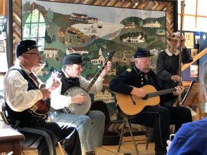 The 6th New Hampshire Volunteer Infantry’s Contra-band performs Saturday, Aug. 19 at the West Milford Museum. From left are Craig Smith on mandolin, Rob Brembt on banjo, Walt Dewey on guitar and Beth Salvatori, who is playing a wash tub bass. (Photos by Kathy Shwiff)