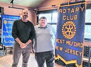 Tom Ziegenbalg inducts new Rotarian Sean Kenney.