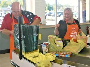 Township Council GOP Candidate Kevin Goodsir and Mayor Michele Dale bag groceries at Shop Rite on Saturday morning as part of the chain's drive for local food pantries. Charles Kim photo