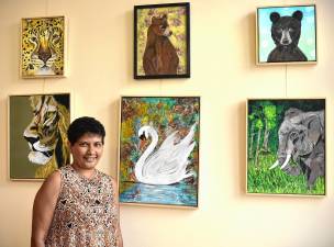 SS1 Sue Siva with her paintings on display at the West Milford Township Library. (Photos by Rich Adamonis)