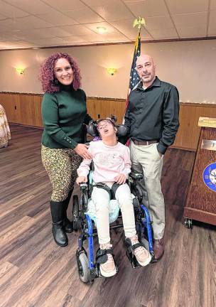 Nicole Yurchka, mother, Mariella Scarpa, 10, ambassador, Joe Scarpa, father, pose for a photo.