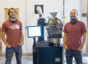 Tyler (left) and Alex Correll with their coffee bean roaster. Photos by Vera Olinski.