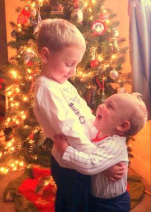 Submitted by: Toni Vogel of Warwick, N.Y. "A precious Christmas moment between brothers (Justin Vogel, age 4 and Joshua Vogel age 1). We just finished decorating our Christmas tree and I was taking pictures of the boys. After much frustration because they wouldn't stay still for a picture, I said "ok, we are all done". Then,out of the blue, my younger son went over to his big brother and hugged him. Luckily, my camera phone was still in hand to capture this moment! Its brotherly love at Christmas time!"