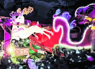 Santa Claus waves from his sleigh on a visit to West Milford.