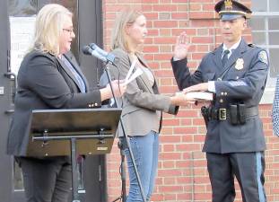 Mayor Michele Dale administers the oath of office to West Milford Police Chief James DeVore with his wife Heather holding a Bible. Photos Ann Genader.