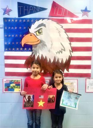 Amelia and Bella Campos honoring their father Rafael Campos who could not attend this year due to deployment.