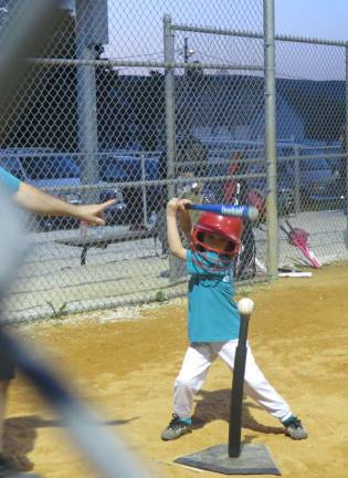 Batter up! The West Milford Little League had a tremendous season. Here, one of the t-ball participants keeps her eyes on the ball as she winds up to swing. Photo by Patricia Keller