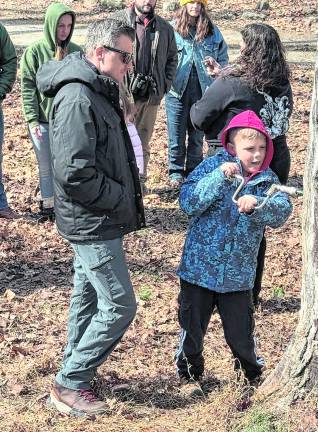 Eugene Dunaev watches son his son Brandon Dundee, age 11, of Mahwah, prepare a maple tree for inserting the tap.