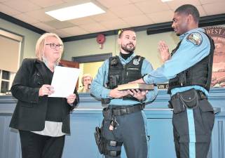 West Milford’s newest police officer, Jordan Faulkner (right), was sworn in by Mayor Michele Dale during the Township Council meeting on Wednesday, Nov. 12. Officer Jordan Primavera, who also serves as the Police Department’s field training officer, held the Bible during the ceremony.