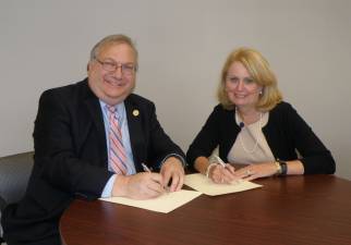 Photo provided Dr. Steven Rose, president of Passaic County Community College and Dr. Helen Streubert, president of the College of Saint Elizabeth sign articulation agreements for Passaic County Community College students to easily transition to the College of Saint Elizabeth.