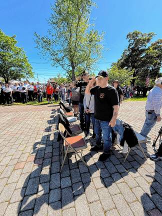 Residents salute during the ceremony. (Photo by Denise von Wilke)