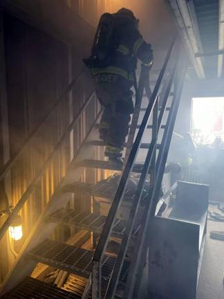 Wesr Milford firefighter Matt Weaver advances a hose to the second floor during drill last month at the indoor fire training center located at the Passaic County Public Safety Academy in Wayne, N.J.