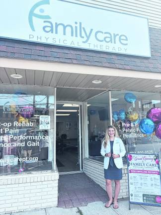 Dr. Nicole Mustafa poses in front of Family Care Physical Therapy.