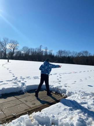 Dan Doyle, owner of the Oasis, a disc golf center in Warwick, N.Y., after throwing a disc in the snow.