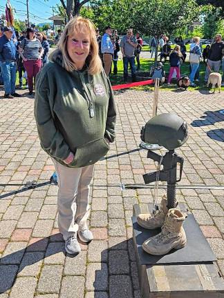 Shirley Parrello stands next to a new display at Veterans Memorial Park. Her son Brian was killed in Iraq on Jan 1, 2025. His dogtag was added to the helmet, rifle and boots. (Photo by Rich Adamonis)