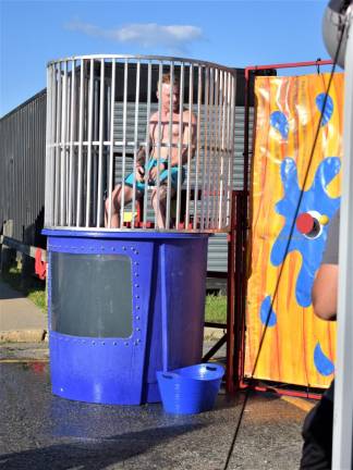 West Milford Patrolman Kyle Butera sits in the dunk tank at the National Night Out celebration. (Photos by Fred Ashplant)