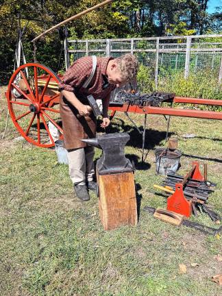 Zane Every demonstrates blacksmithing. He created traveling bellows based on photos of bellows in the 1800s.