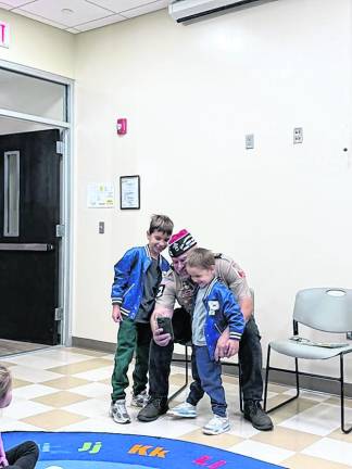 Ezekiel and Enzo Autio are shown with Rudy Hass.